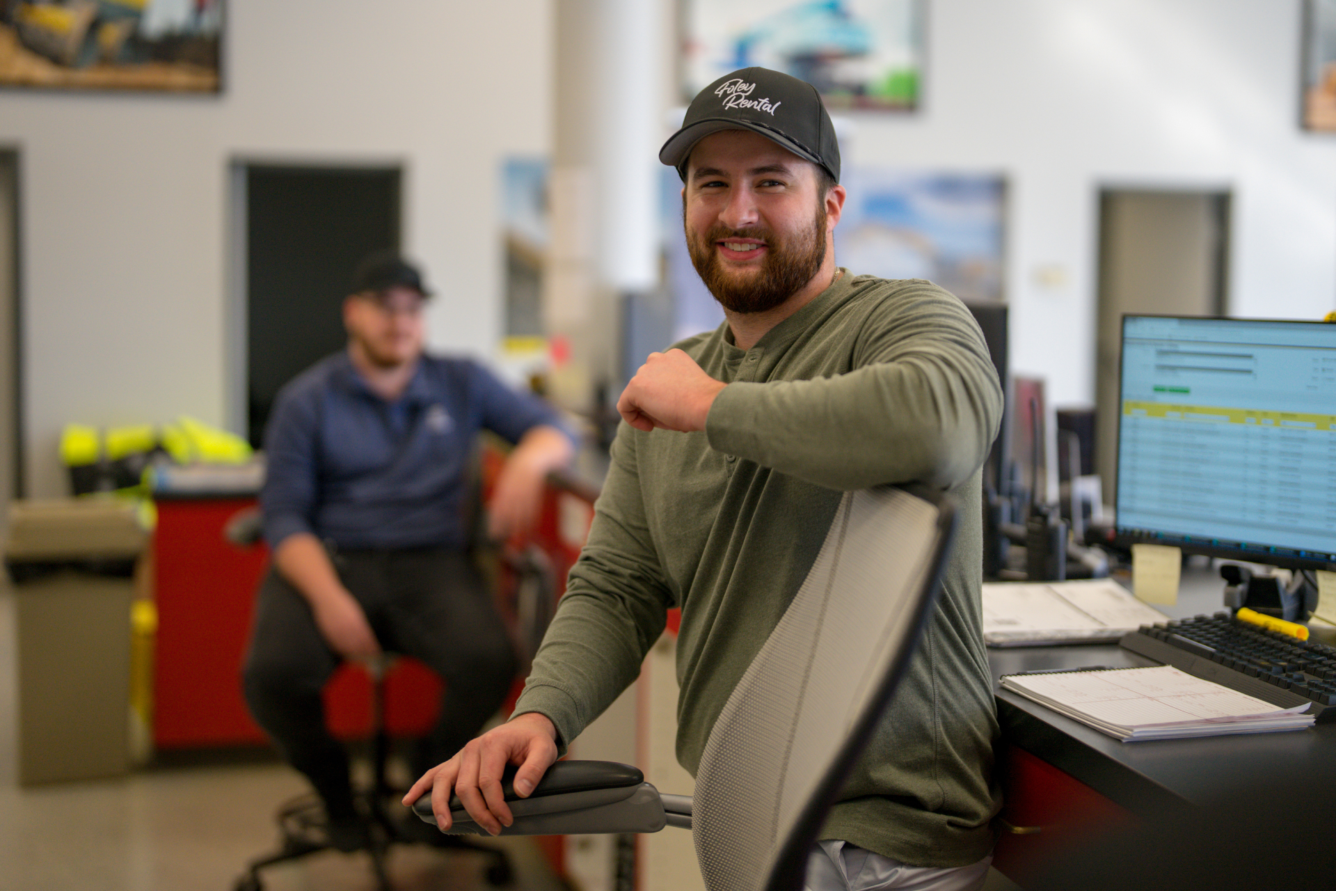Employee smiling standing at desk